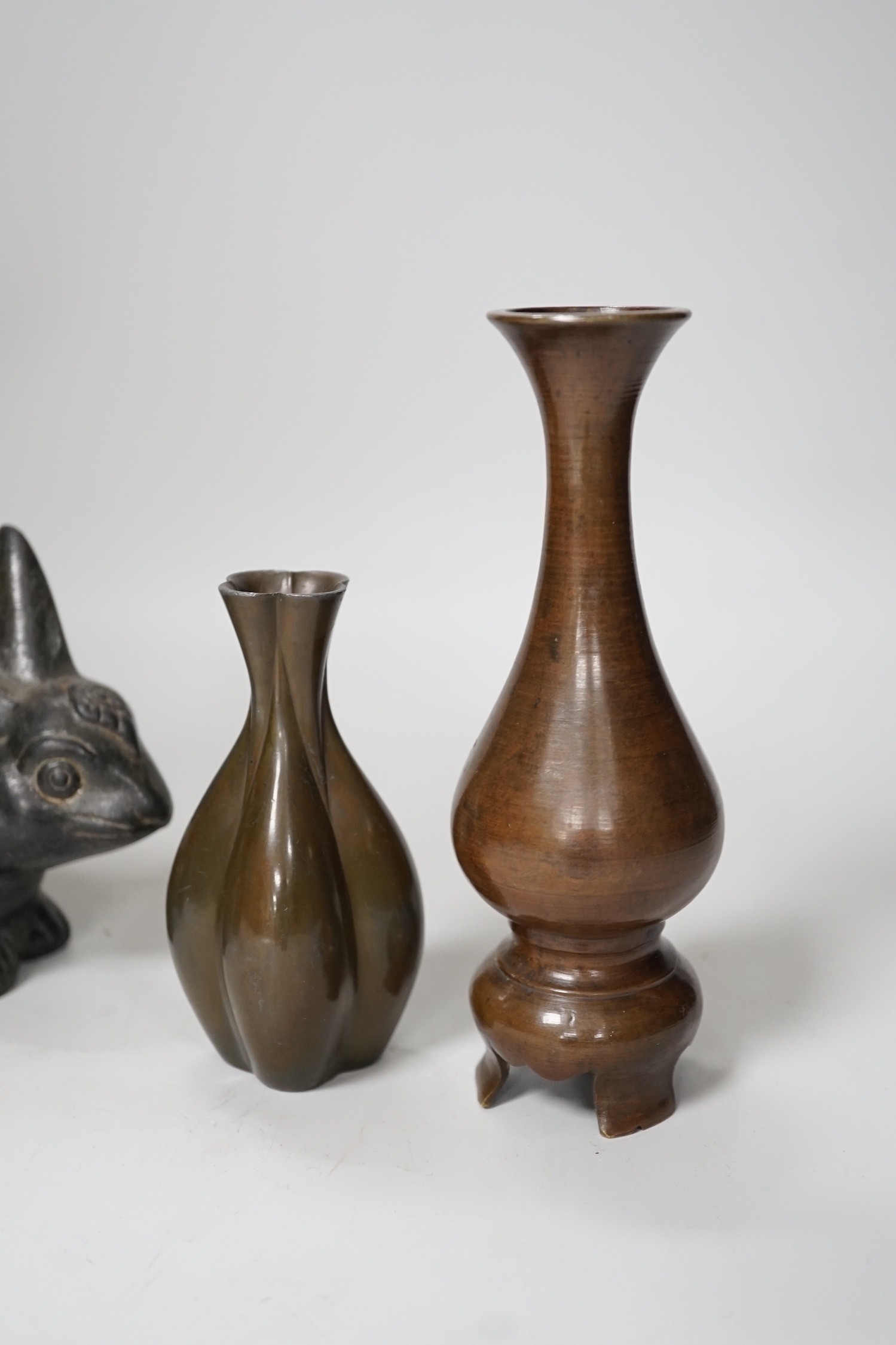 A pair of Chinese bronze models of rabbits, together with two vases and a dragon seal. Tallest 16cm